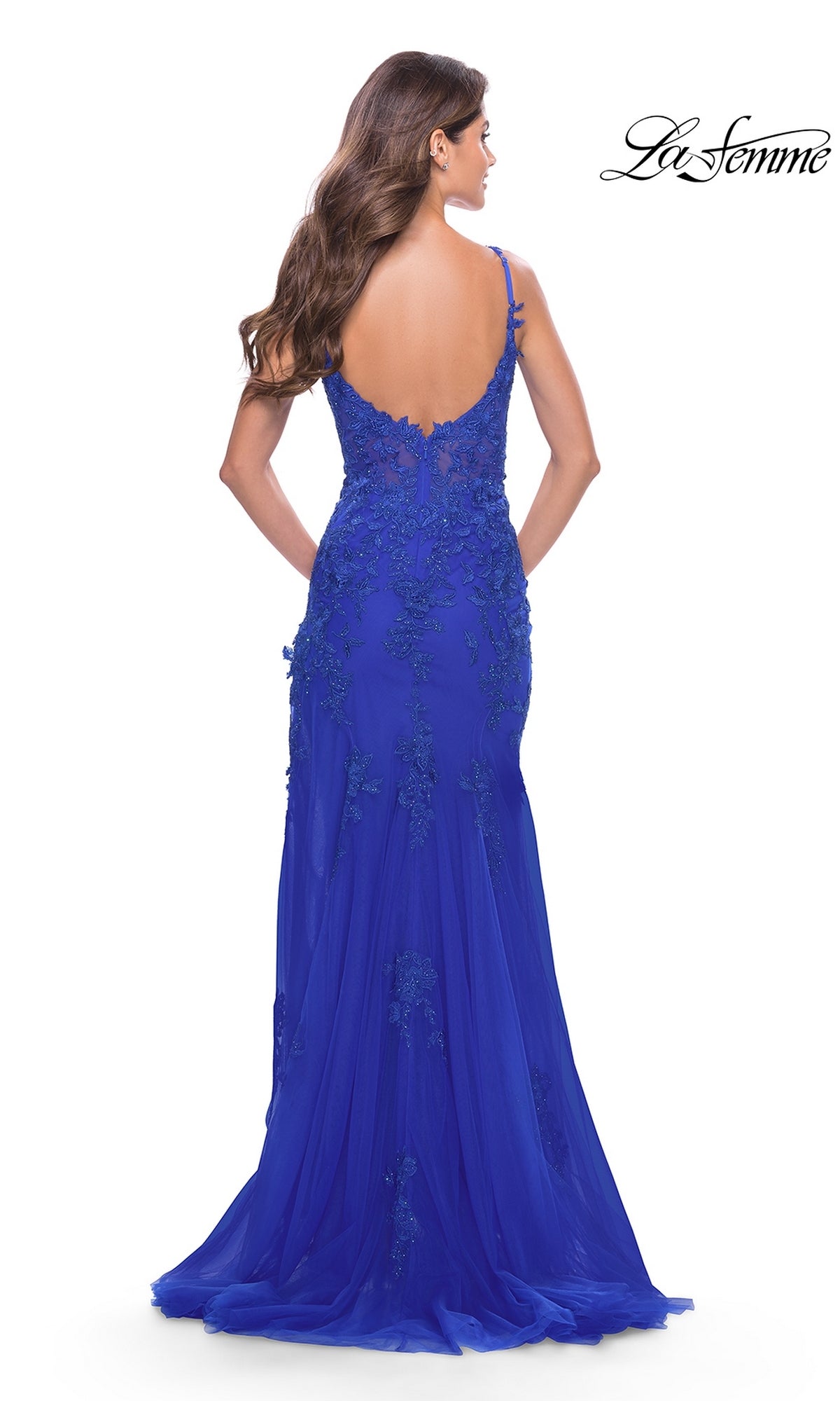 A woman models the La Femme Sheer-Corset-Bodice Long Prom Dress 30767 in royal blue, featuring a floor-length v-neckline, lace embroidery, and a low back, posed against a plain white background.